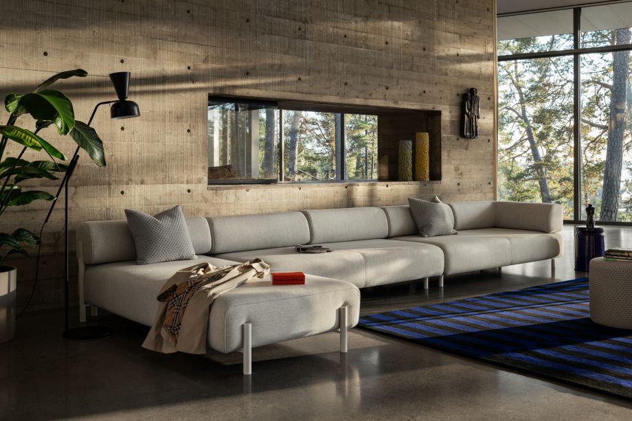 A lifestyle image of a living room scene featuring Palo Modular Corner Sofa Left, Stripe Rug, Bon Pouf Round, Dash Cushion and Last Stool.