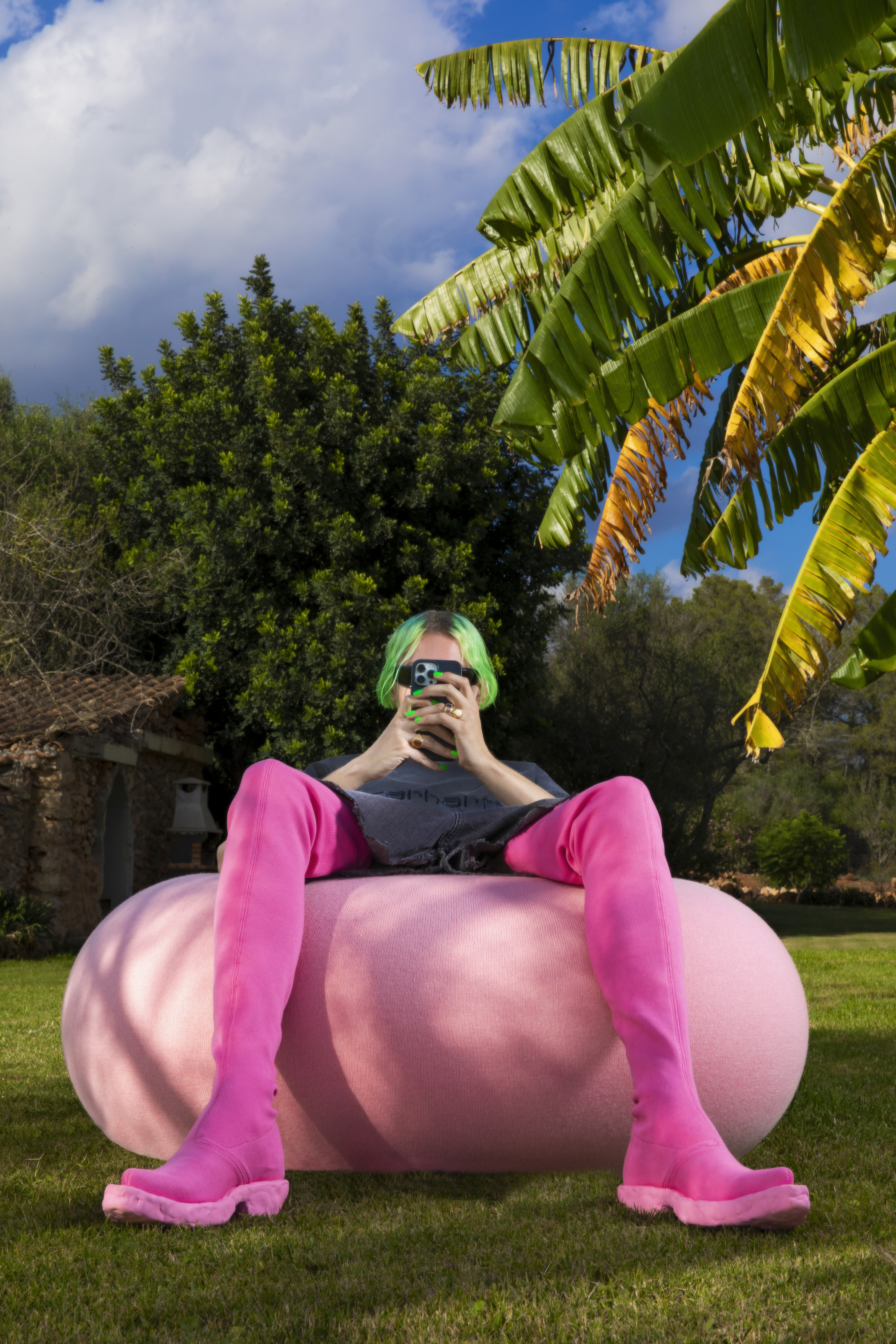 Achilles sits casually on our [Boa Pouf Cotton Candy](/furniture/sofas-and-poufs/boa/30494)