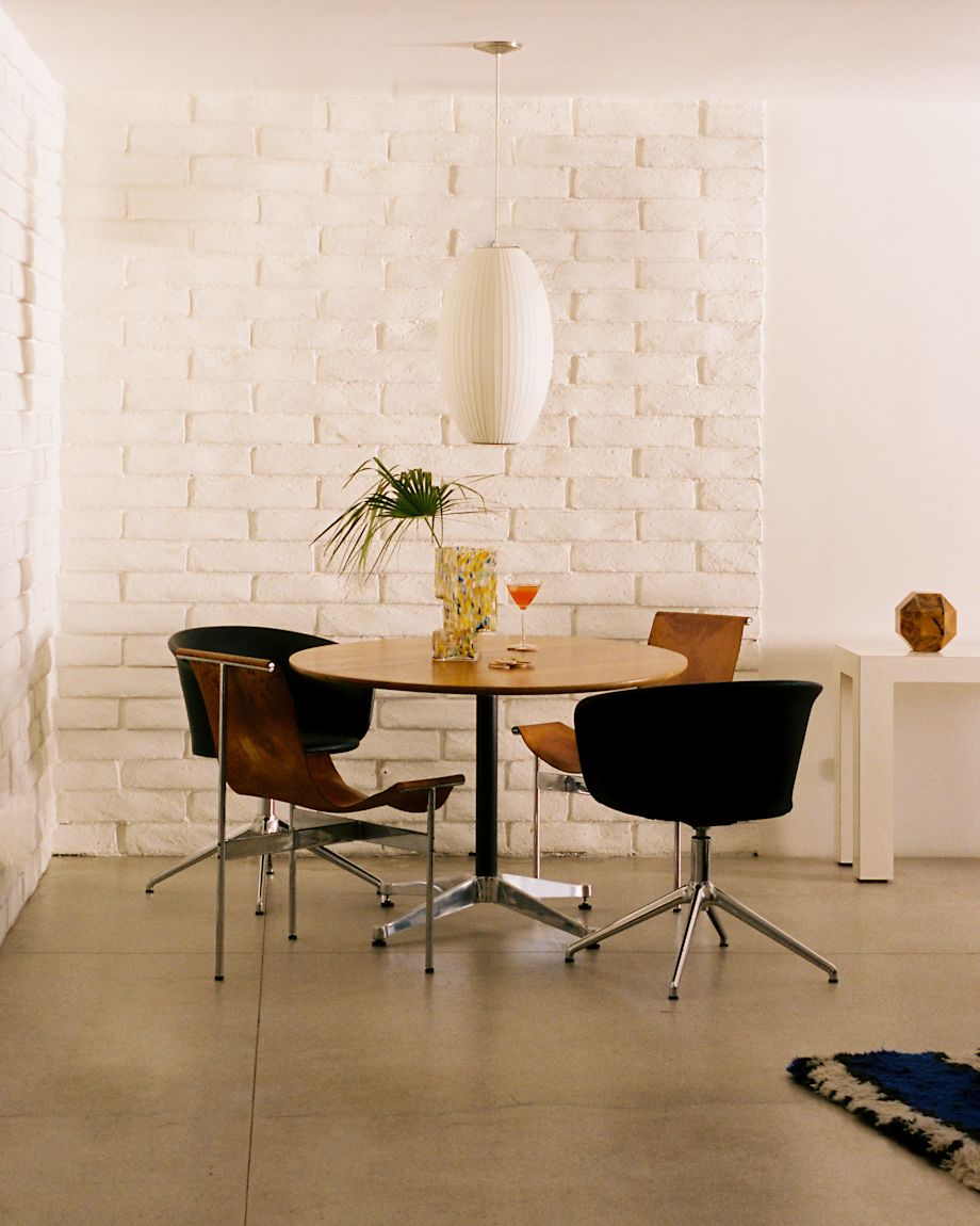 A lifestyle image of a dining scene featuring Kendo Swivel Chairs, Brute Vase, and Disco Coasters.