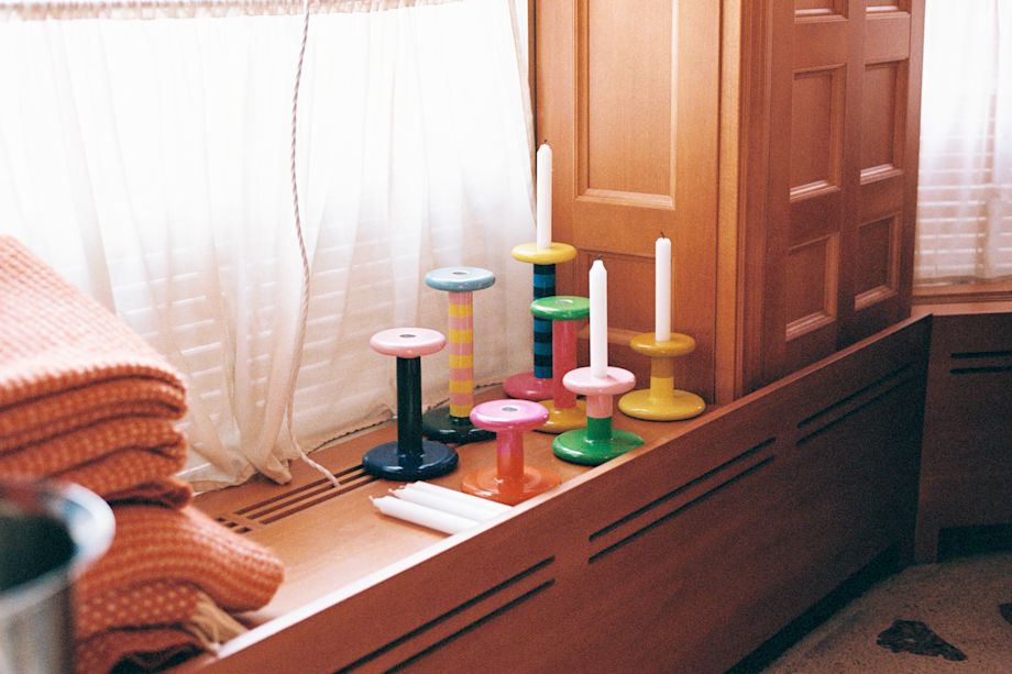 A lifestyle image of a dining scene featuring Pesa Candle Holders.