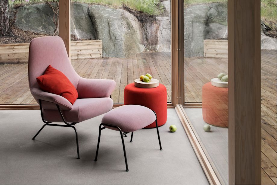 A lifestyle image of a lounge scene featuring Hai Lounge Chair + Ottoman, Storm Cushion and Bon Pouf Round.