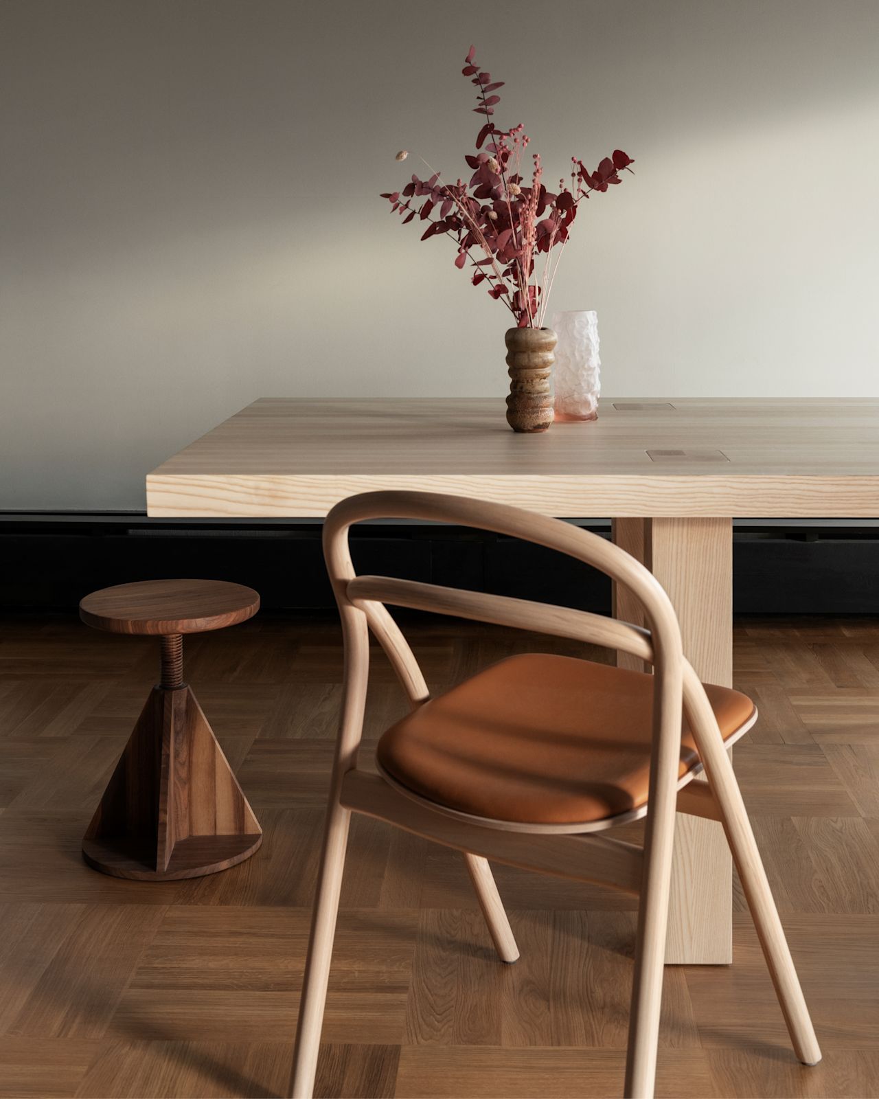 A lifestyle image of a dining scene featuring Max Table, Udon Chair, and All Wood Stool.