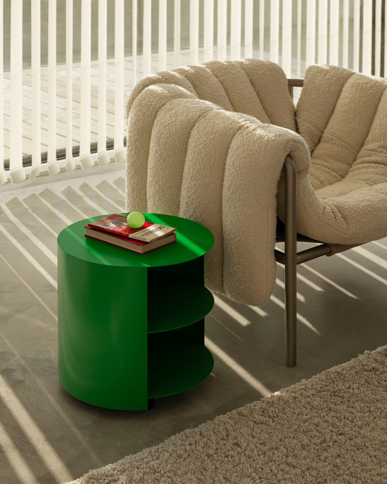 A lifestyle image of a lounge scene featuring Puffy Lounge Chair and Hide Side Table.
