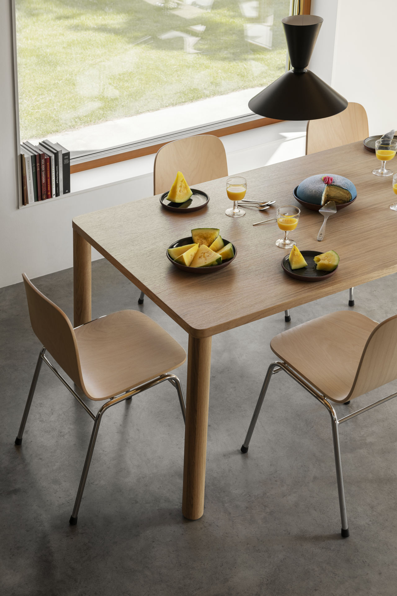 A lifestyle image of a dining / kitchen scene featuring Alphabeta Pendant Light, Log Table and Touchwood Chairs.