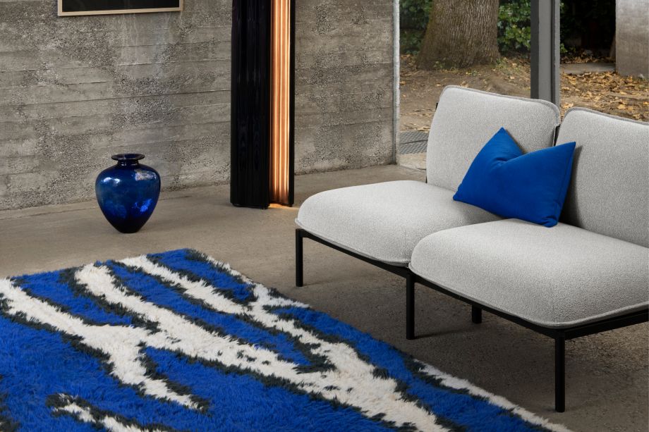 Hem - A living room scene featuring Kumo 2-Seater Sofa in Porcelain, Storm Cushion Large Sky, and Monster Rug Ultramarine Blue / Off-White.