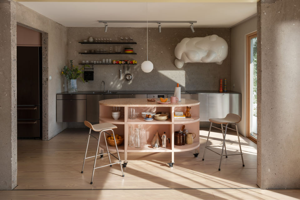 A lifestyle image of a kitchen scene featuring Touchwood Counter Stools, Spill Kitchen Roll Holder, and Coco Pendant Light.