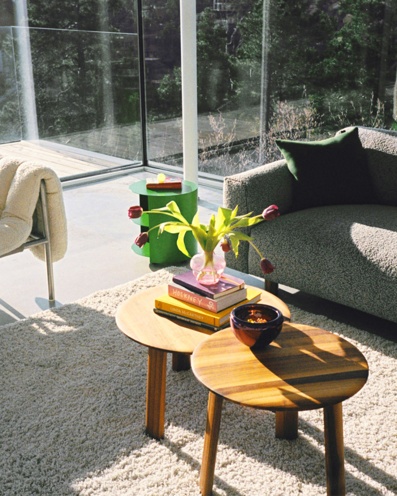 An analog image of a living room/lounge scene featuring Koti Sofa, Neo Cushion, Hide Side Table, Alle Coffee Tables, and Puffy Lounge Chair.