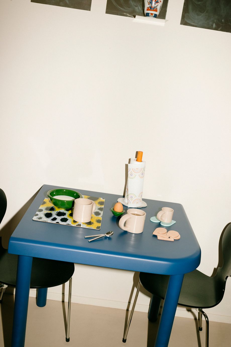 A lifestyle image of a kitchen/dining scene featuring Spill Kitchen Roll Holder, Monster Placemat, Disco Coasters, and Bronto Tableware.