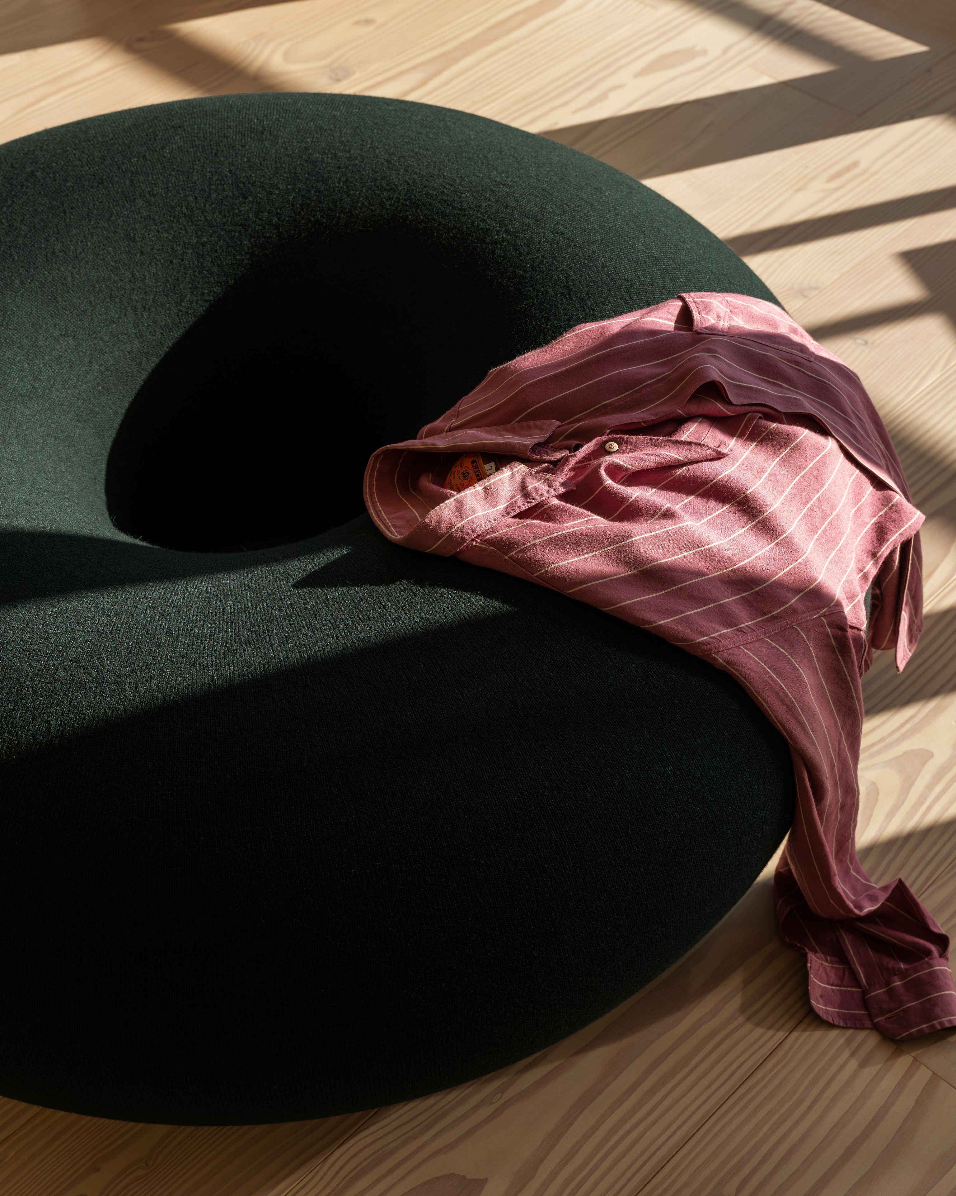 A lifestyle image of a lounge scene featuring Boa Pouf Pine.
