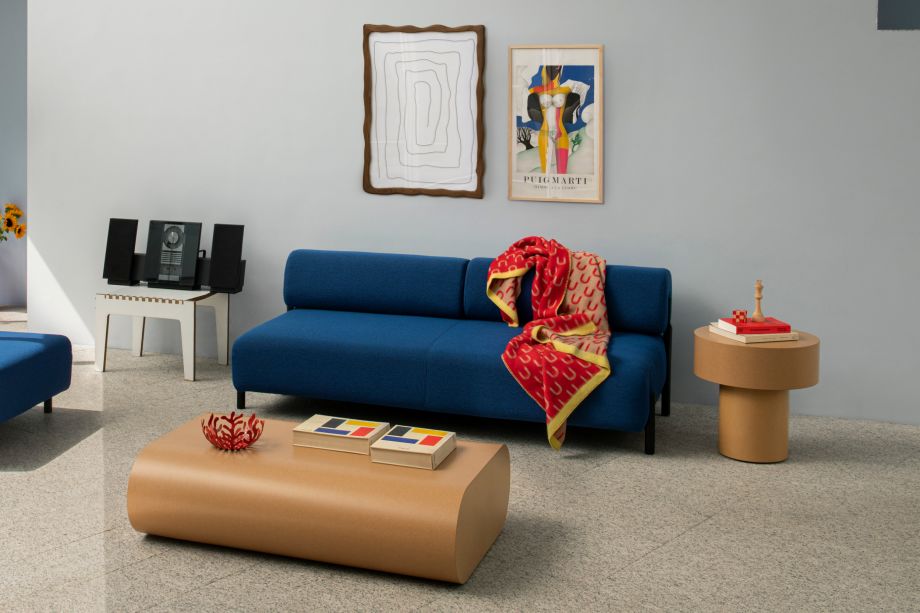 A lifestyle image of a living room scene featuring Palo Modular Sofa, Arch Throw, Wiggle Box Frame, Stump Side Table and Stump Coffee Table.