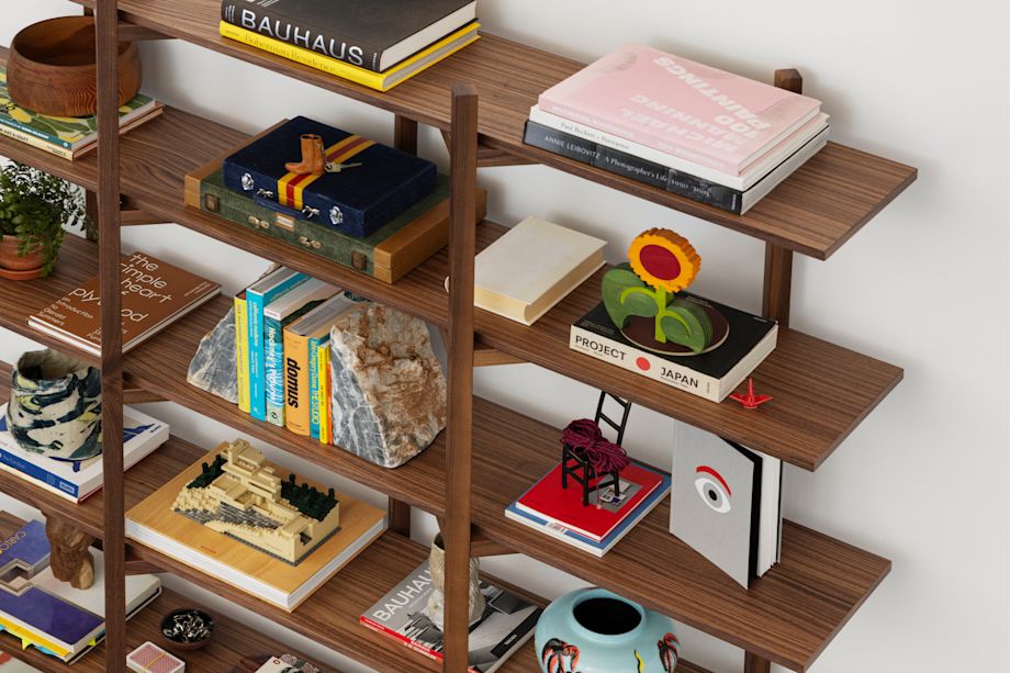 Hem - An aerial view of a Zig Zag High Shelf in the shade Walnut with books and other decorative objects placed in its shelves.