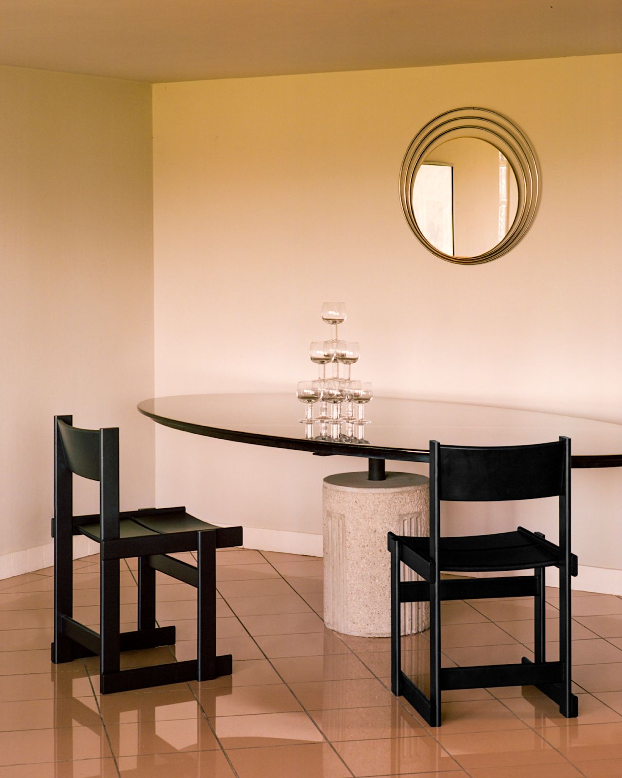 A lifestyle image of a dining scene featuring Bullnose Chairs and Fars Glas.