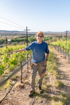 Photo of Eric Glomski standing in a vineyard