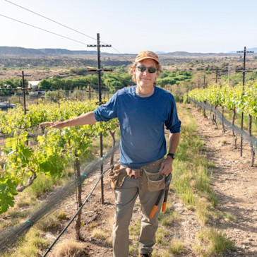 Photo of Eric Glomski standing in a vineyard