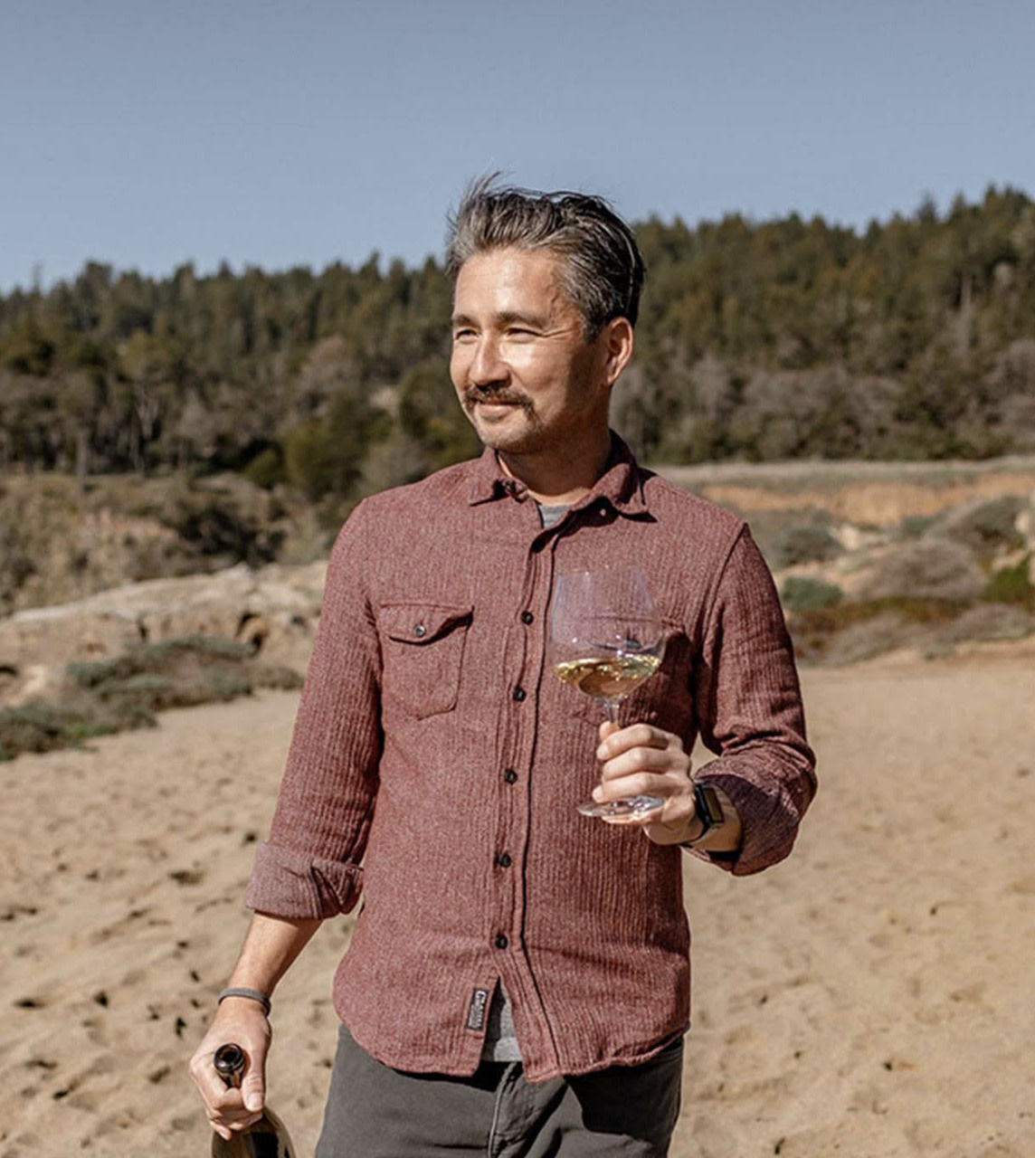 Photo of Rob Fischer holding a wine glass outside