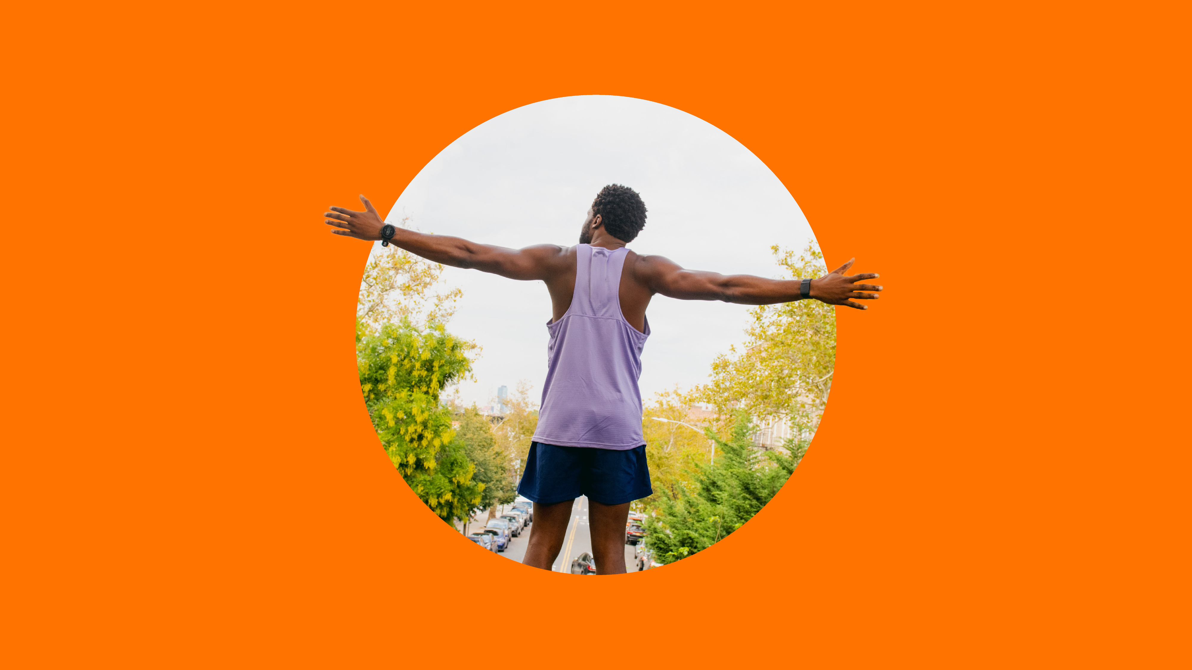 Man outdoors with arms stretched out