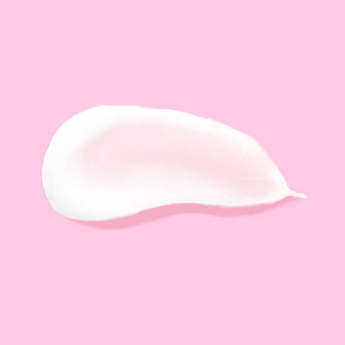 A white smear of Hair Balm conditioner on a pink background | Waterless Hair Care