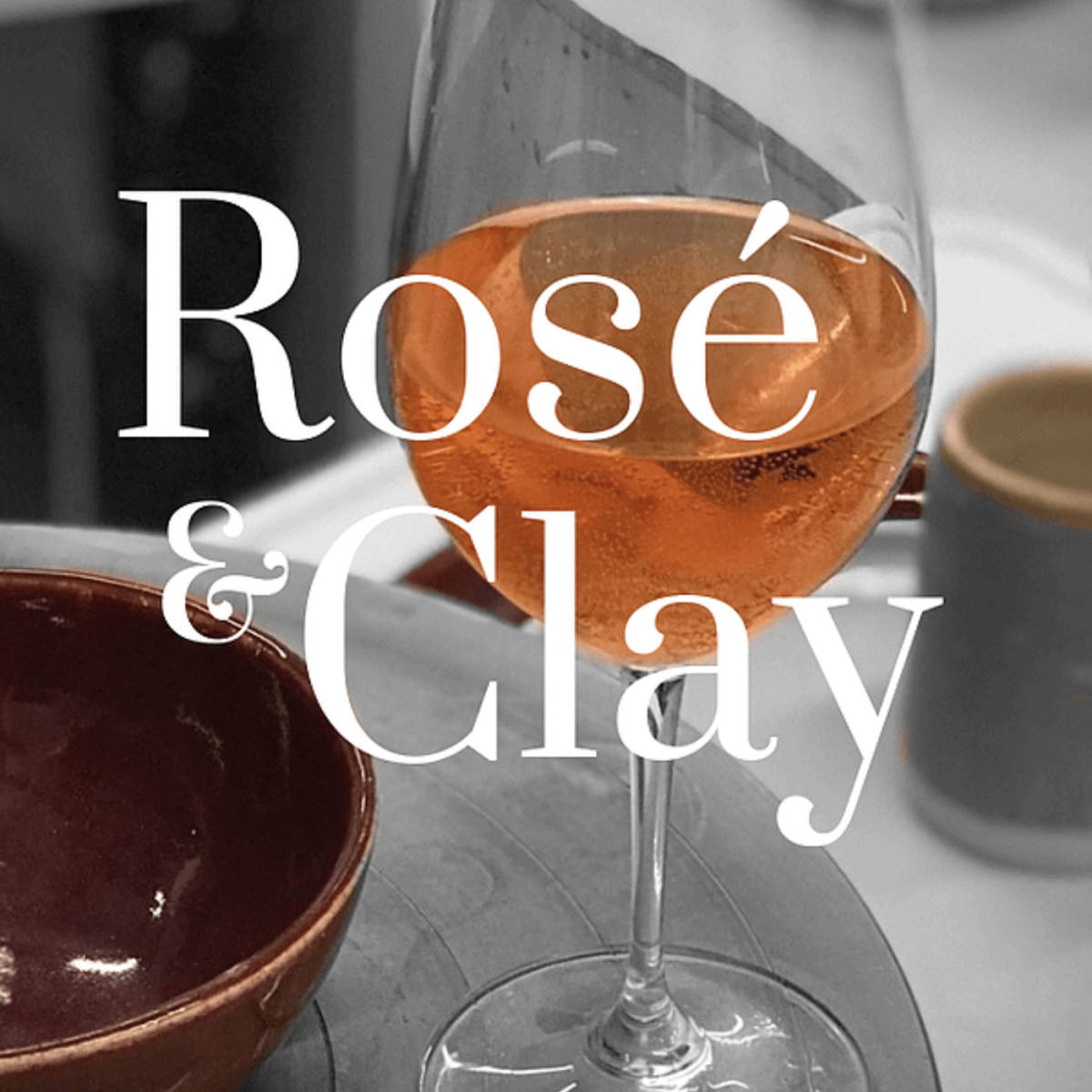 Glass of wine and ceramic bowl with Rosé and Clay branding