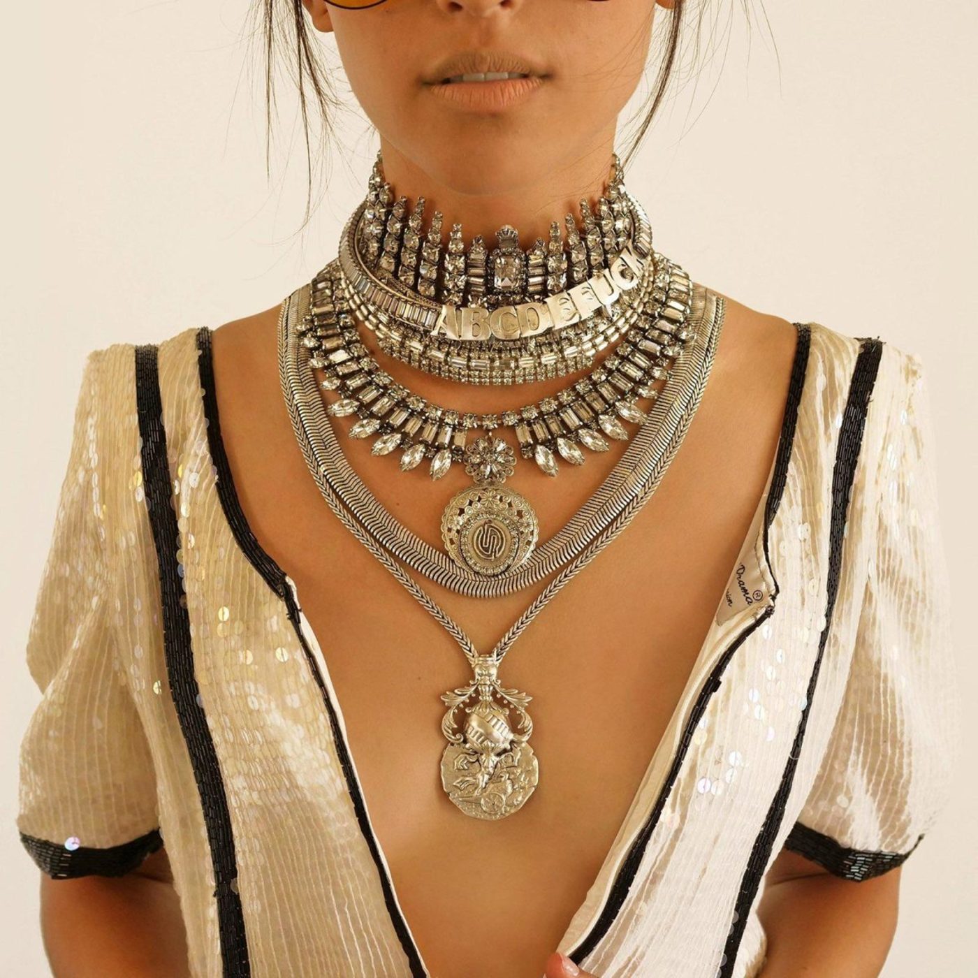 girl wearing stacked metal necklaces