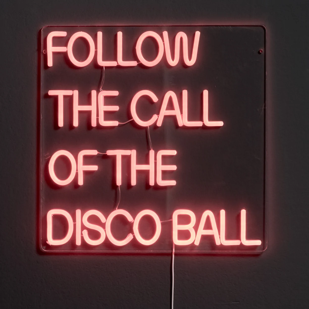 Neon wandlamp met rode letters: follow the call of the disco ball