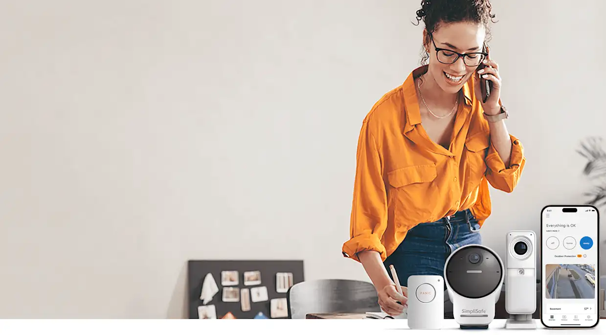 Image of woman with home security products, including a panic button, an outdoor camera, and an indoor camera