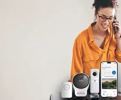 Image of woman with home security products, including a panic button, an outdoor camera, and an indoor camera