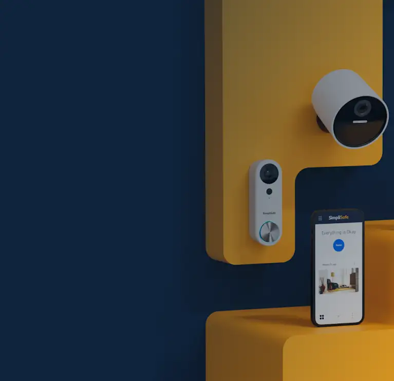 Simplisafe doorbell, outdoor camera, and cellphone with the Simplisafe App opened up