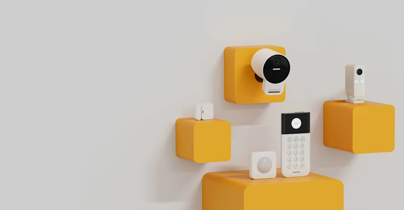 SimpliSafe products placed on yellow shelves on the wall