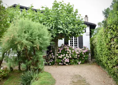 Image of a home with a beautiful garden and flowers in front of it