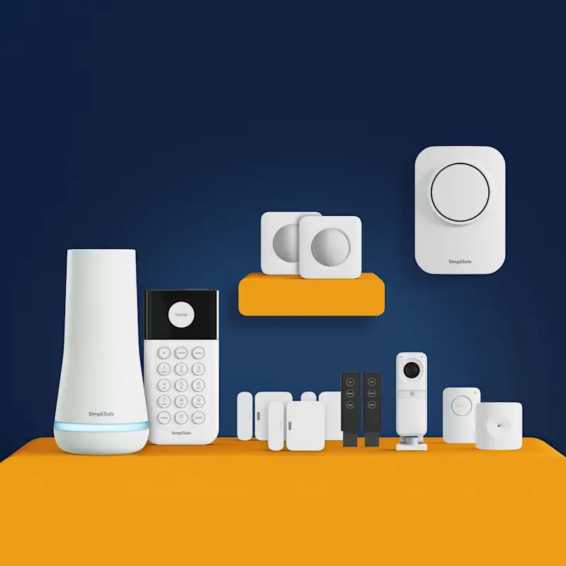 UK Package Essentials, showcasing a base station, entry sensors, glass break sensors, and a camera.