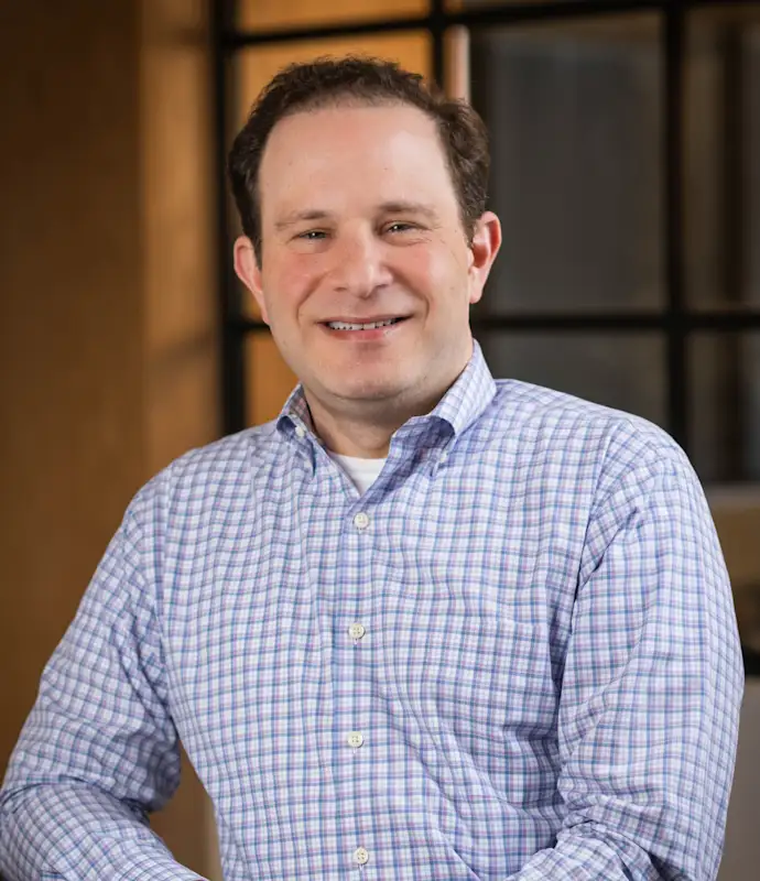 Brian Bloch standing in an indoor setting.