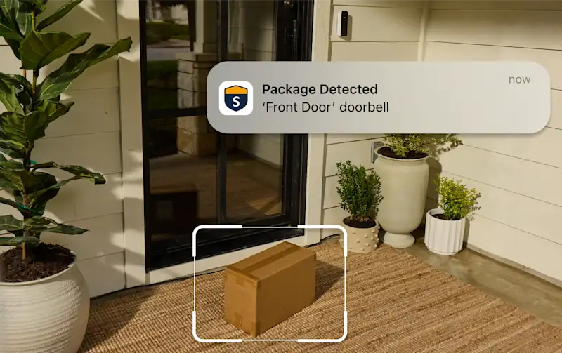 Front porch with a package on the doormat and a phone notification: "Package Detected. Front Door doorbell."