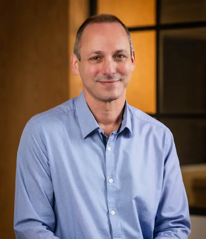 Scott Braun smiling and standing in an indoor setting.