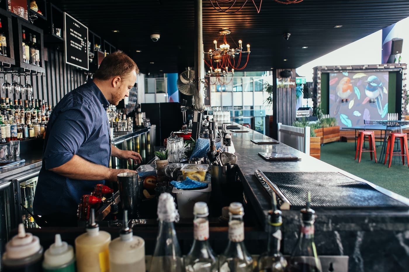 Bartender prepping behind bar