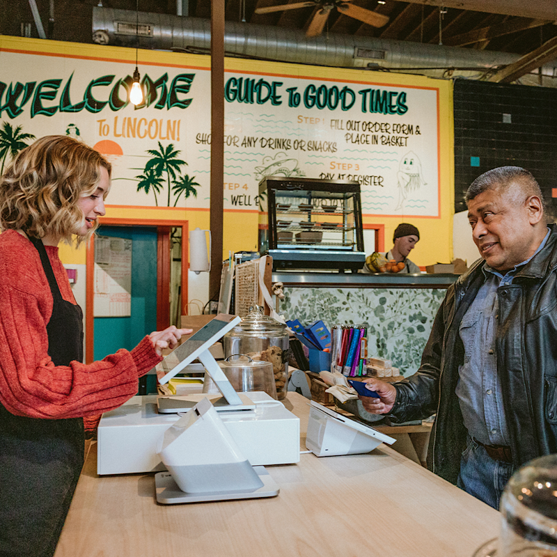 Customer checking out at a store counter with Clover POS – real retail environment
