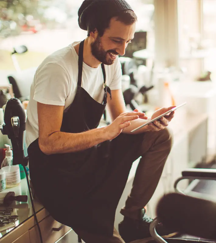 Worker at a salon looking at a device