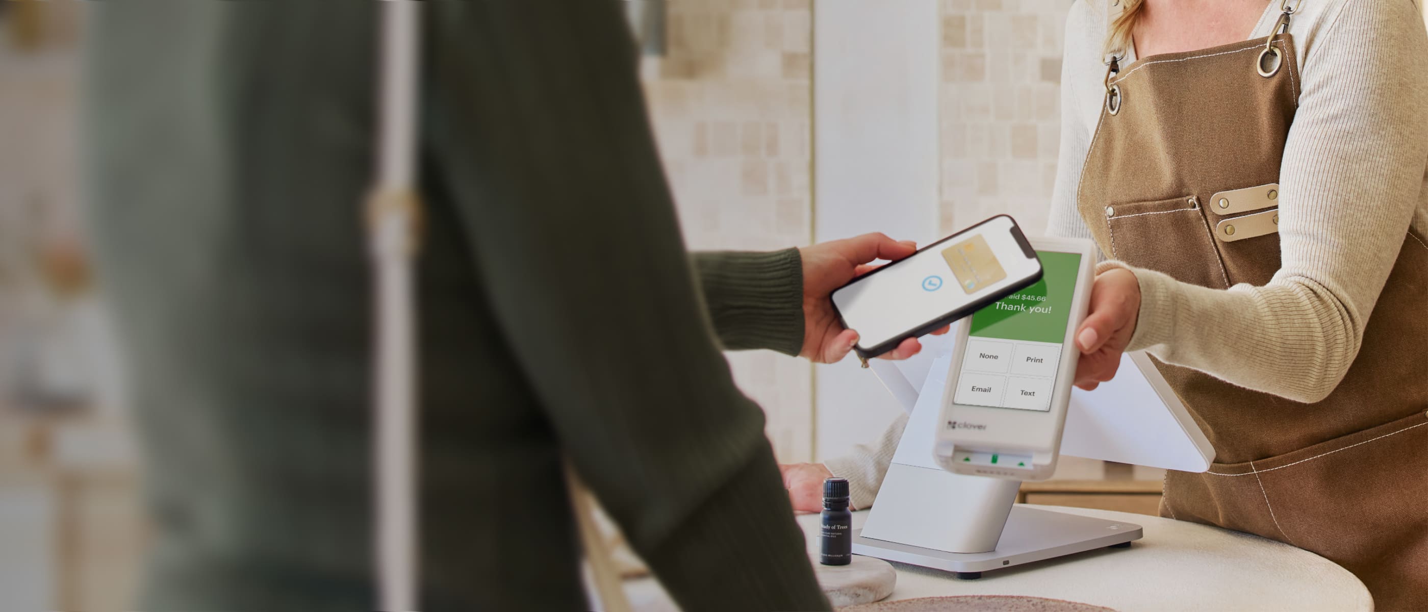 Merchant takes contactless payment on Clover Flex. 