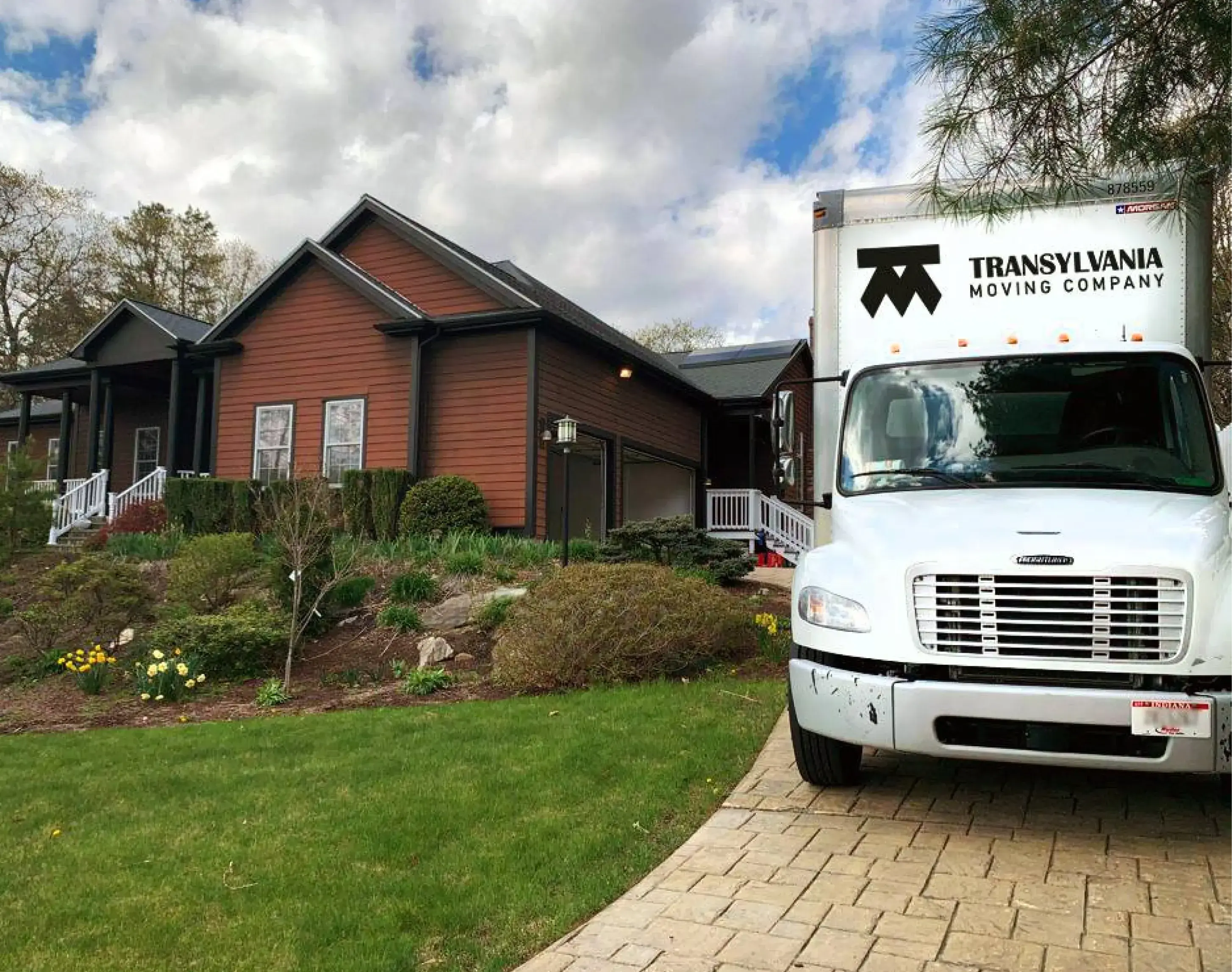 Transylvania moving company truck parked in a customer's driveway