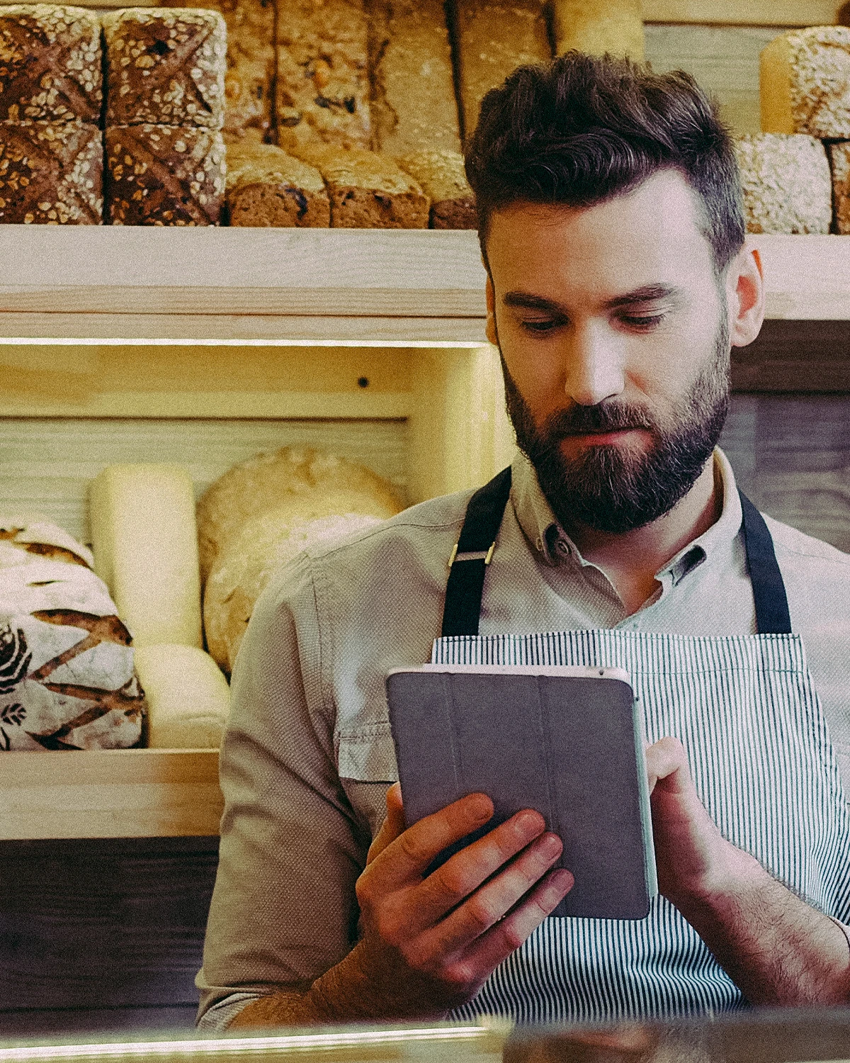 Man in bakery using a tablet