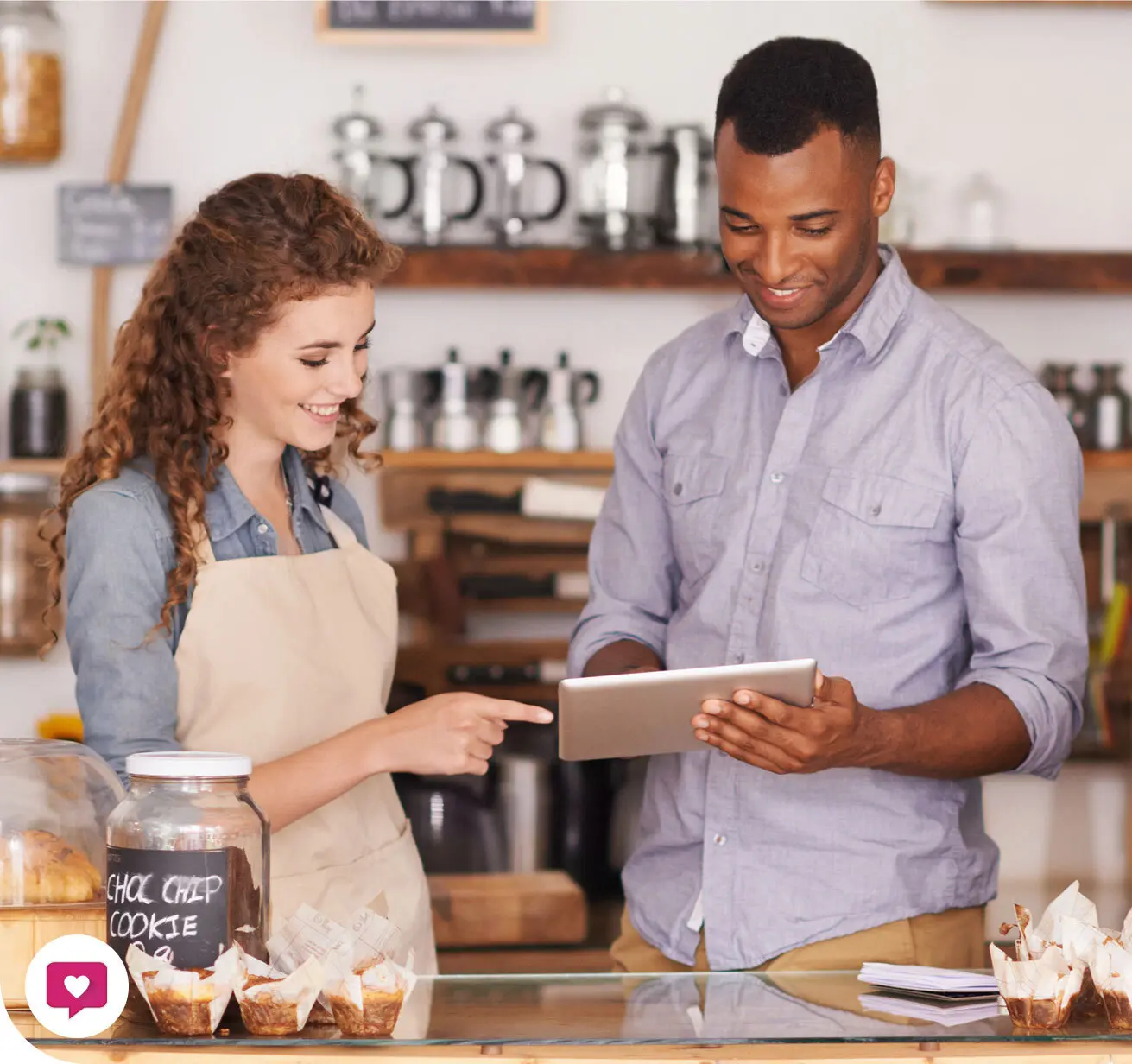 Man teaching worker how to use POS System at a coffee shop