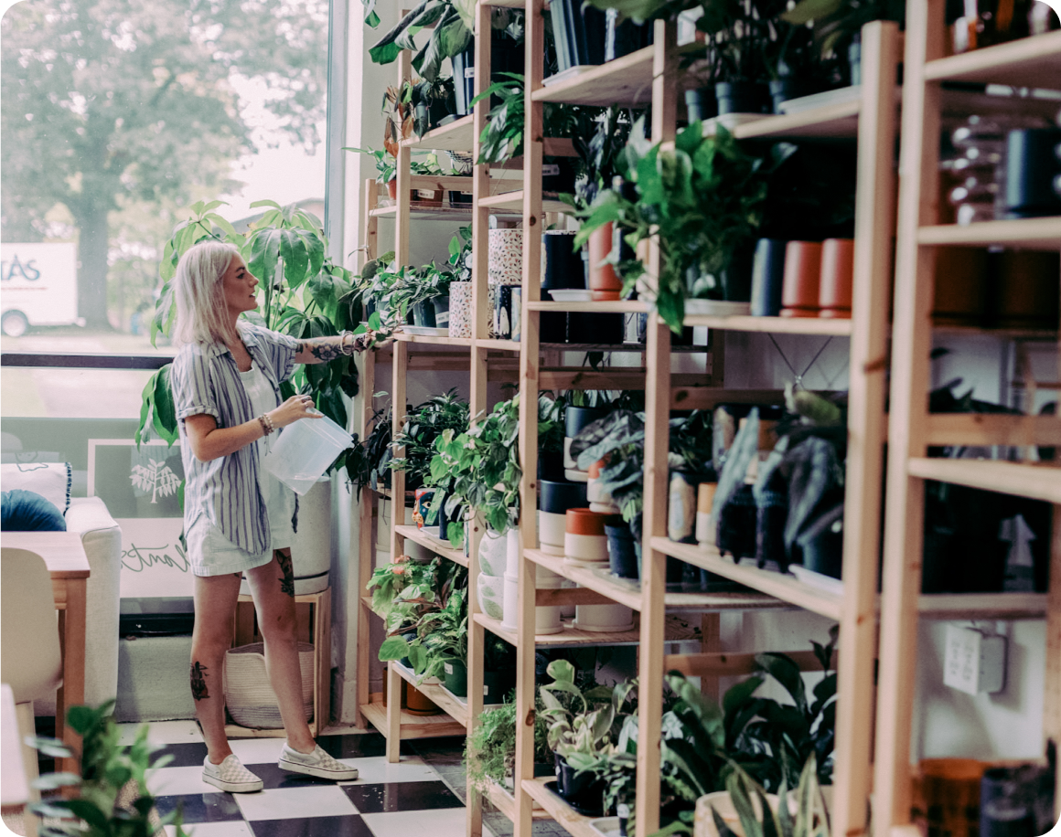 Woman looks at inventory in plant shop