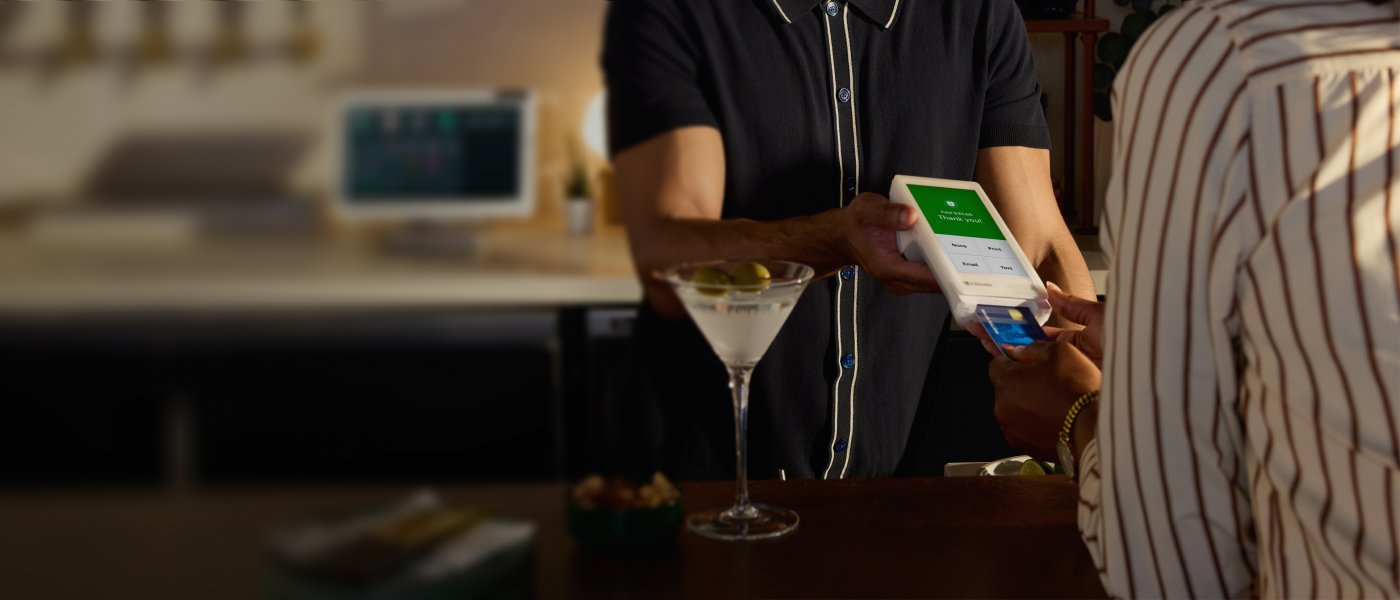 Bartender takes a payment on a Clover Flex. 