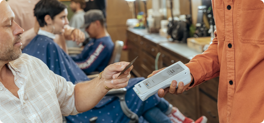 mini 3 on counter of barber shop owner while styling hair