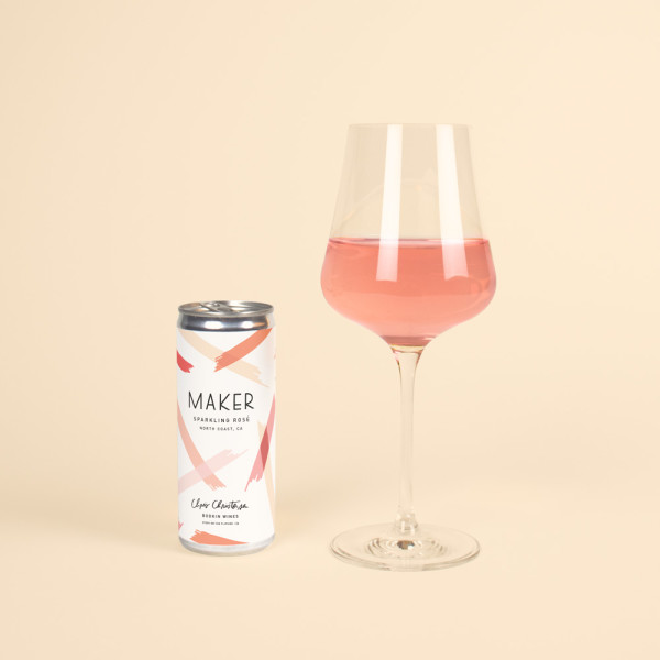 The Maker Sparkling Rosé by Bodkin Wines in a can next to wine glass. 