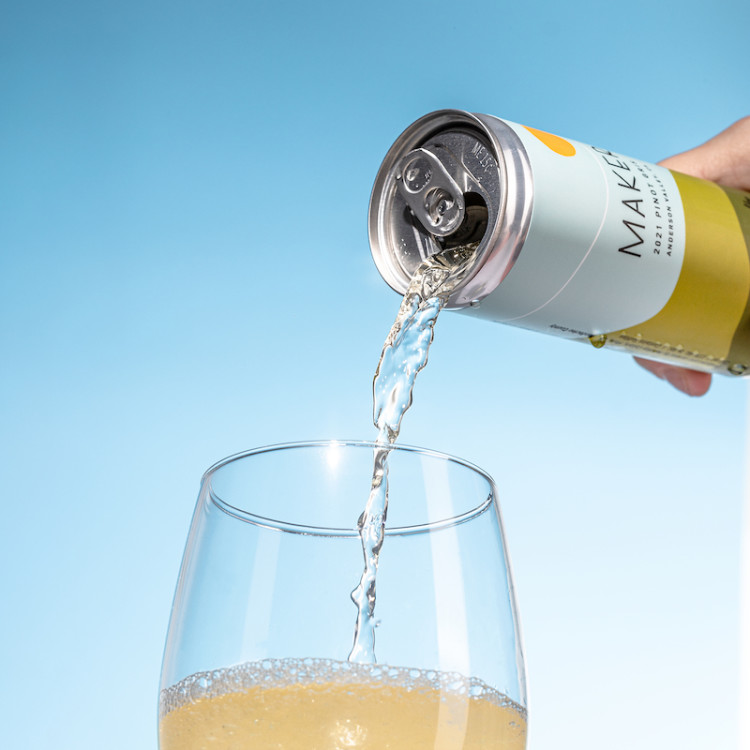 Can of Maker pinot gris pouring into a glass. 