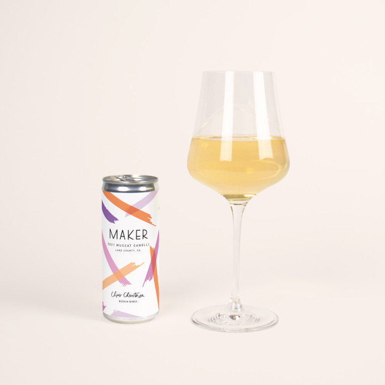 White wine glass next to the can of the Maker Muscat Canelli.