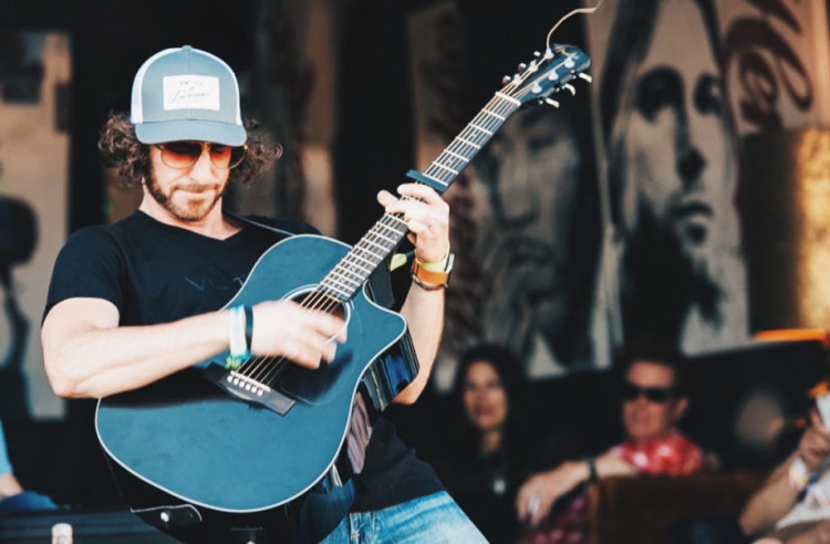 Ian Devereux White playing guitar