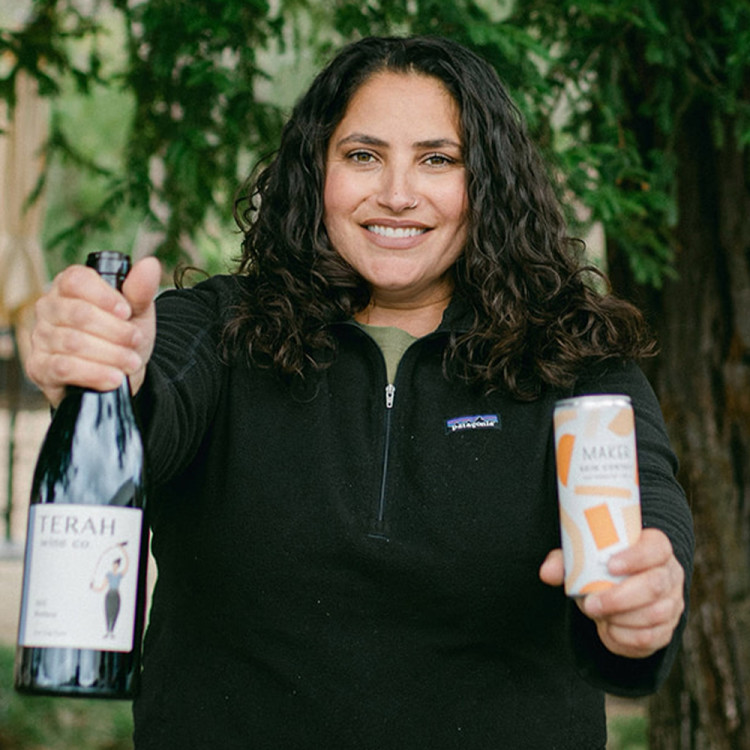 Terah Bajjalieh holding a can and bottle of Orange Vermentino.