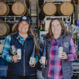 Photo of Tara and Mireia with Camins 2 Dreams bottles and wine cans of Albarino.