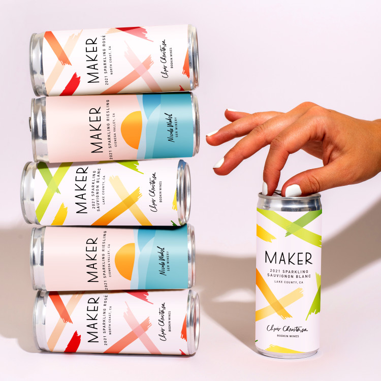 Sparkling Wine Mixed Pack, cans stacked with hands. 